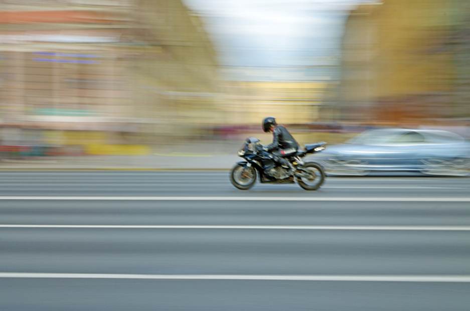 A person riding a motorcycle on the street

AI-generated content may be incorrect.